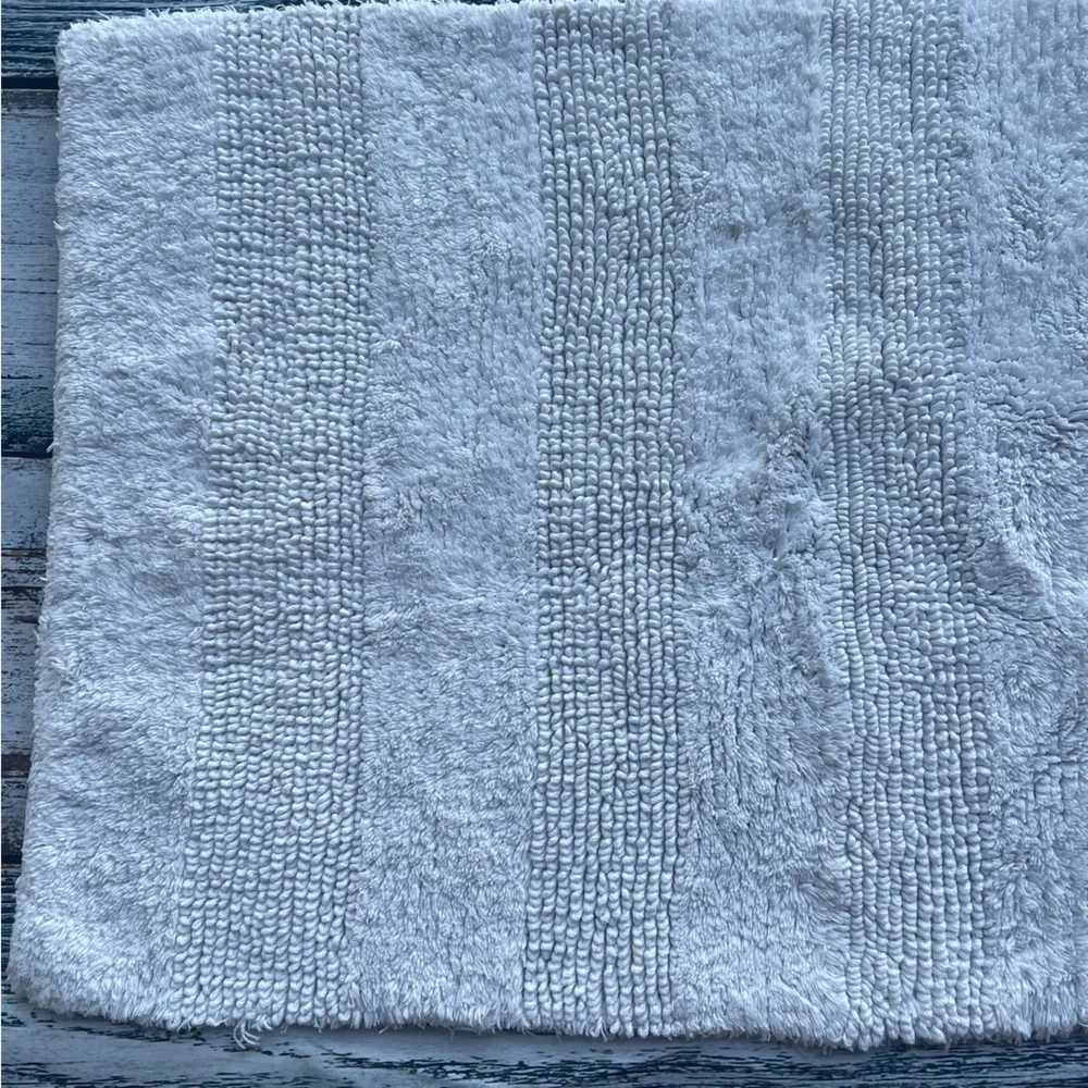 DKNY white bathroom rug 33in x 19in EUC
